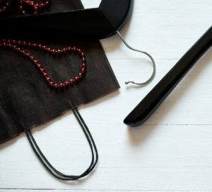 Red and Black paper shopping bag with hangers on white background